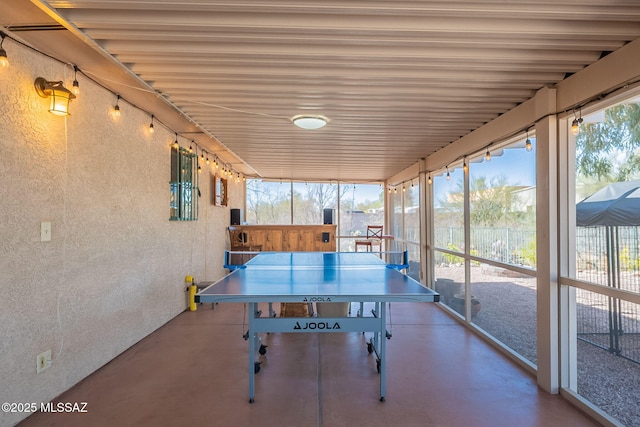 rec room featuring finished concrete flooring