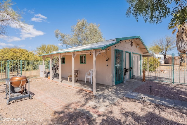 rear view of house with a patio, a gate, and fence