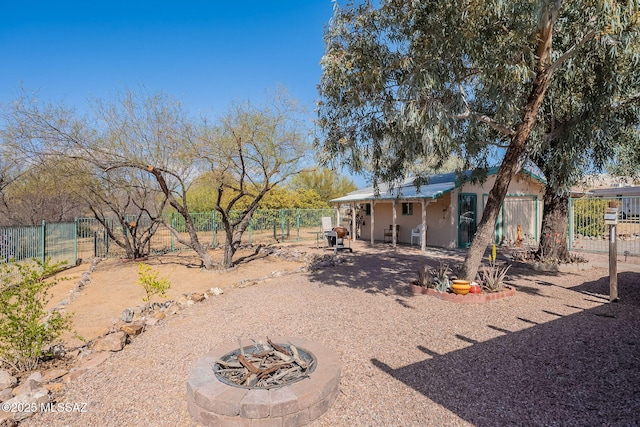 view of yard featuring a fire pit and fence