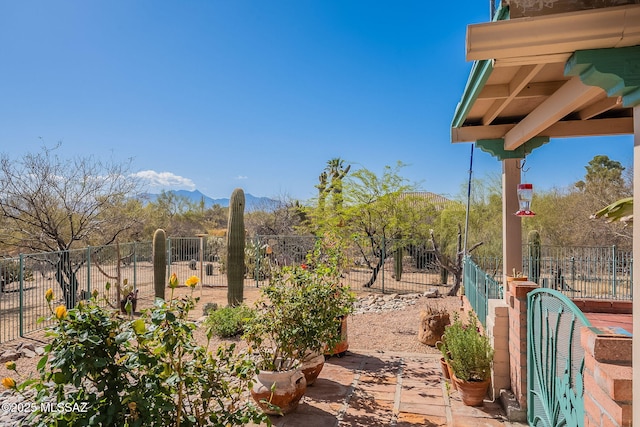 view of yard featuring fence and a mountain view