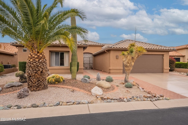 view of front facade with stucco siding, driveway, cooling unit, a garage, and a tiled roof