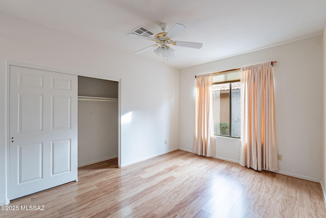 unfurnished bedroom with visible vents, a closet, light wood-style floors, baseboards, and ceiling fan