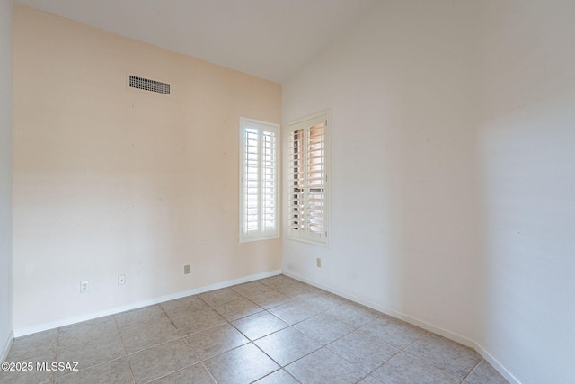 spare room with tile patterned flooring, baseboards, and visible vents