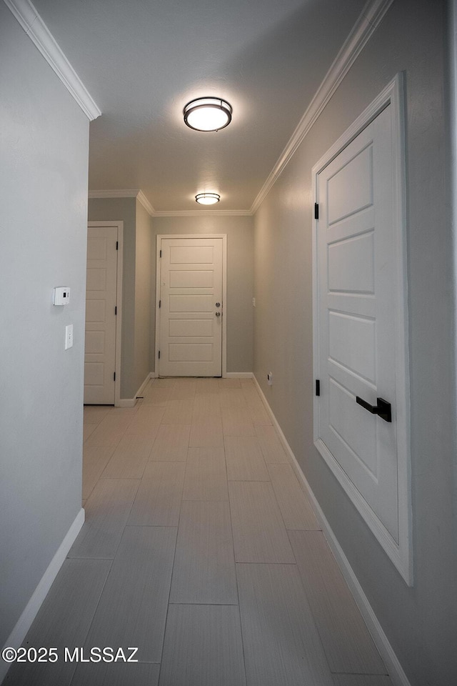 corridor with baseboards and ornamental molding