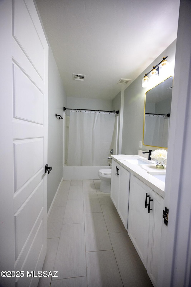 full bath with visible vents, toilet, vanity, and baseboards