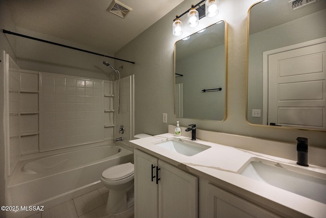 full bath featuring a sink, visible vents, toilet, and double vanity