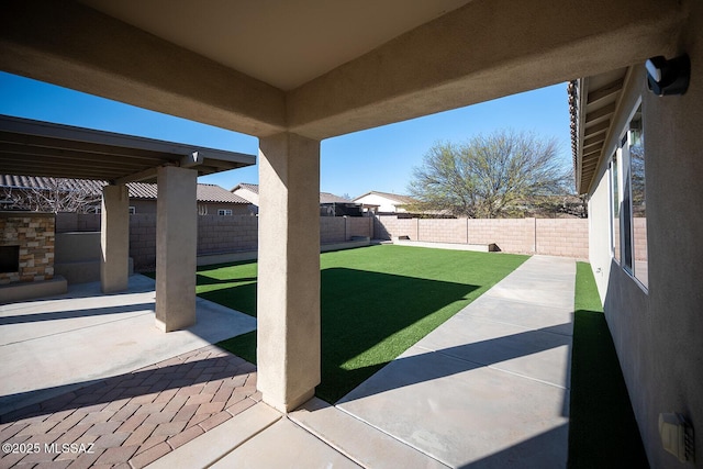 view of yard featuring a patio area and a fenced backyard