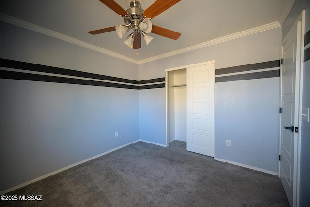 unfurnished bedroom with a closet, dark carpet, baseboards, and ornamental molding