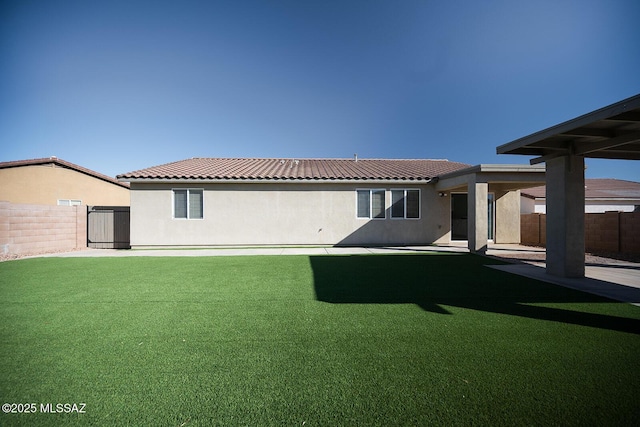 back of property with a patio area, a tiled roof, a fenced backyard, and stucco siding