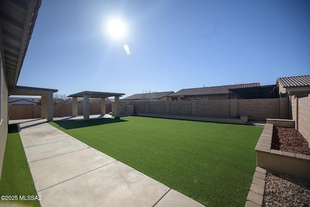 view of yard with a patio area, a pergola, and a fenced backyard