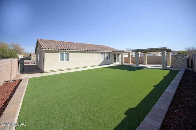 back of house with stucco siding, a patio, a fenced backyard, and a tile roof