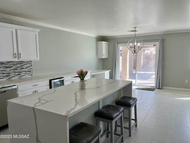 kitchen with dishwasher, crown molding, white cabinets, and tasteful backsplash