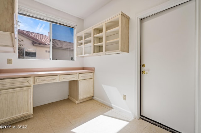 bathroom with baseboards and tile patterned floors