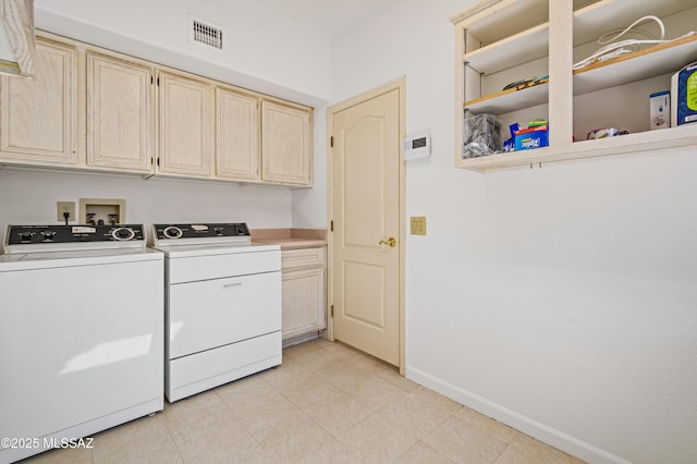 laundry room with washing machine and clothes dryer, light tile patterned floors, visible vents, cabinet space, and baseboards
