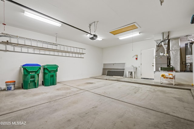 garage with water heater, a sink, and a garage door opener