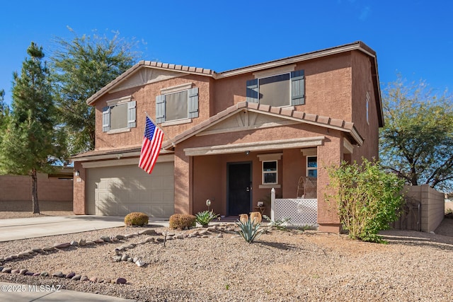 traditional home featuring driveway, a porch, an attached garage, and stucco siding