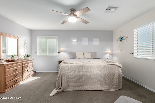 bedroom with a ceiling fan, dark carpet, visible vents, and baseboards