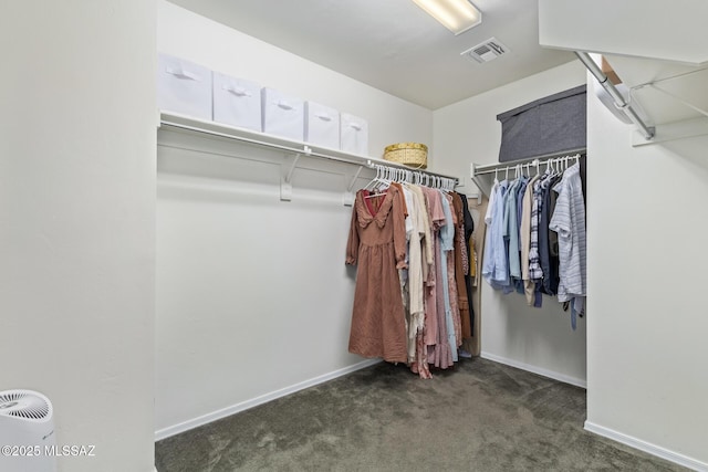 walk in closet featuring visible vents and dark carpet