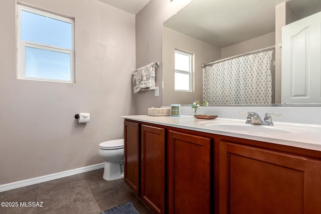 full bath with curtained shower, tile patterned flooring, toilet, vanity, and baseboards