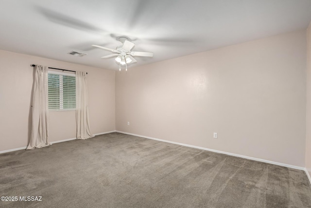 unfurnished room with carpet floors, visible vents, baseboards, and a ceiling fan