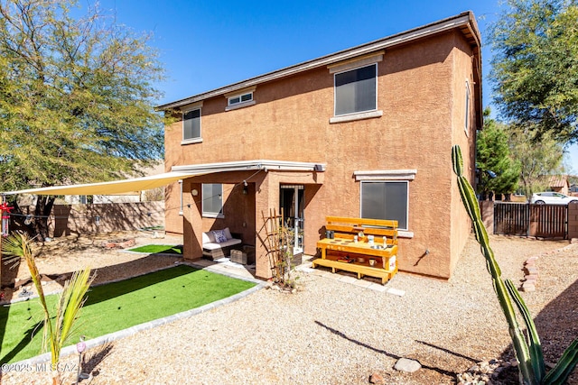 rear view of property with a patio area, a fenced backyard, and stucco siding