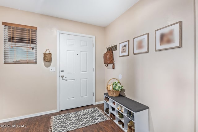 entryway featuring baseboards and dark wood finished floors