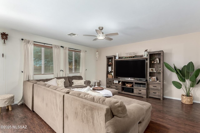 living room with dark wood-type flooring, visible vents, ceiling fan, and baseboards