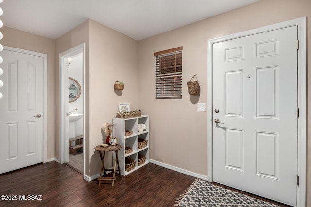 entryway with baseboards and dark wood finished floors