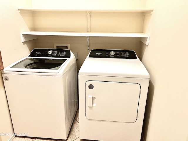 laundry room featuring washing machine and clothes dryer and laundry area