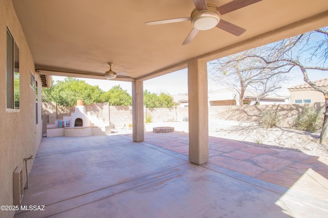 view of patio / terrace featuring ceiling fan, a fenced backyard, and exterior fireplace