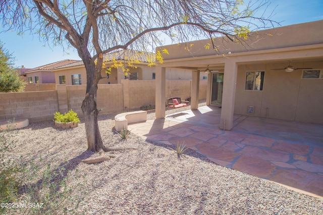 exterior space featuring fence, a ceiling fan, and a patio