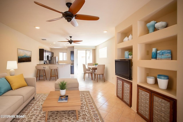 living room with recessed lighting, built in shelves, ceiling fan, and light tile patterned flooring