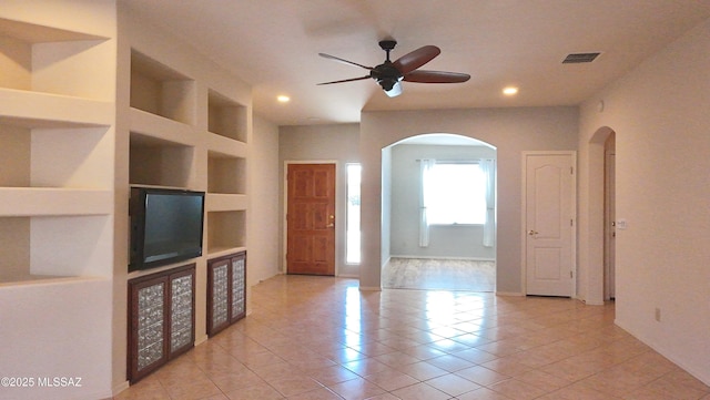 interior space featuring recessed lighting, visible vents, light tile patterned floors, arched walkways, and ceiling fan