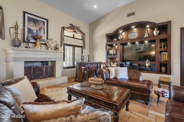 living room featuring recessed lighting, visible vents, vaulted ceiling, and a fireplace