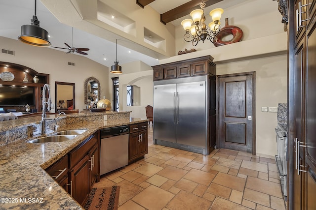 kitchen with decorative light fixtures, visible vents, appliances with stainless steel finishes, a sink, and dark brown cabinetry