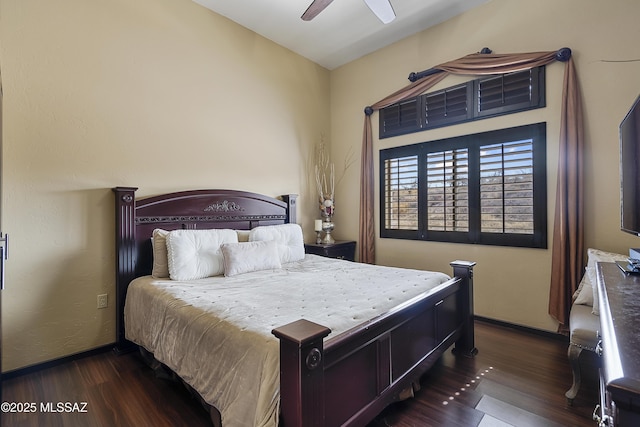 bedroom with dark wood-type flooring, baseboards, and a ceiling fan