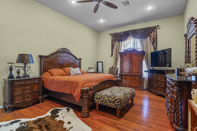 bedroom featuring a ceiling fan, recessed lighting, visible vents, and wood finished floors