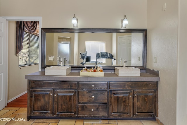 bathroom with vanity and baseboards