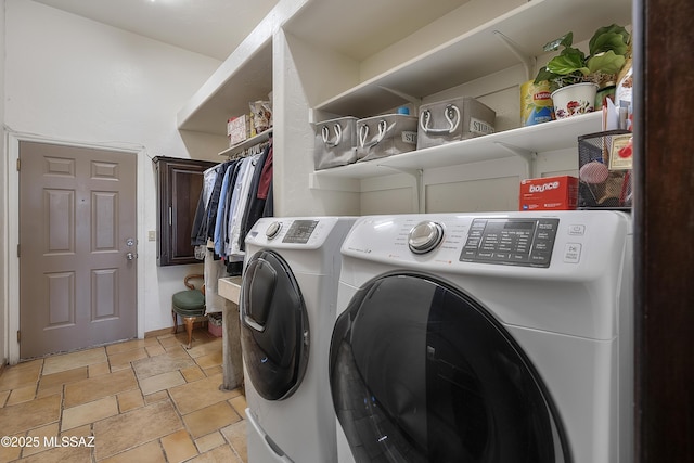 laundry room featuring laundry area, stone tile floors, and independent washer and dryer