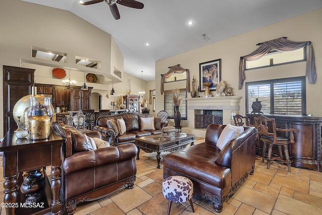 living area featuring high vaulted ceiling, recessed lighting, a fireplace, and a ceiling fan