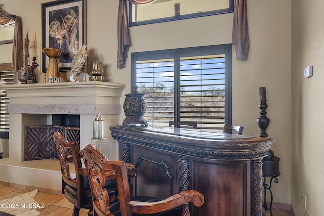 interior details with a fireplace with raised hearth and baseboards