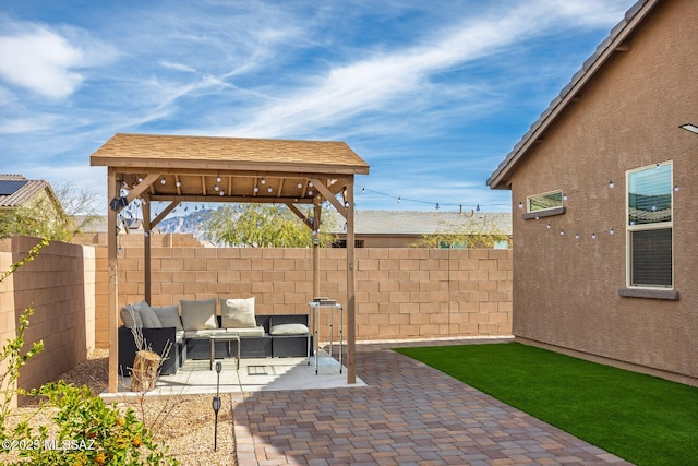 view of patio featuring a gazebo, a fenced backyard, and an outdoor living space