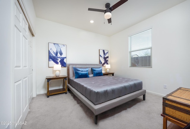 bedroom featuring baseboards, recessed lighting, ceiling fan, a closet, and light carpet