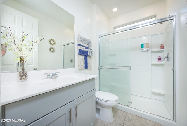 bathroom with toilet, recessed lighting, vanity, tile patterned floors, and a stall shower