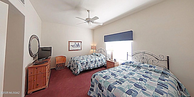 bedroom featuring lofted ceiling, dark colored carpet, and a ceiling fan