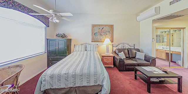 bedroom with ceiling fan, carpet flooring, visible vents, and a wall unit AC