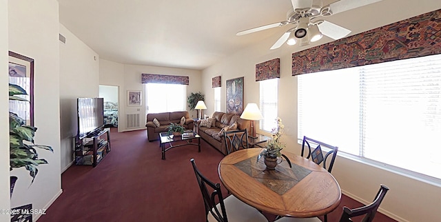 carpeted dining space featuring ceiling fan, visible vents, and baseboards