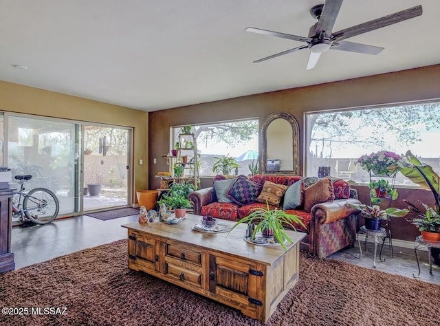 living area featuring a ceiling fan and plenty of natural light