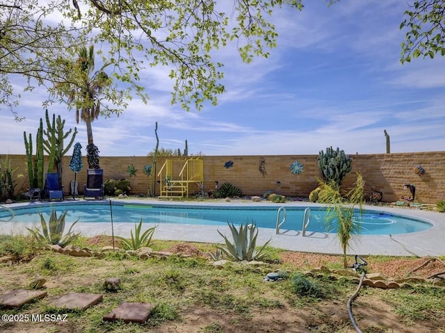 view of swimming pool featuring a fenced backyard