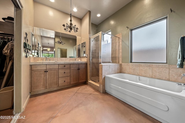 full bath featuring a notable chandelier, a shower stall, a garden tub, and a sink